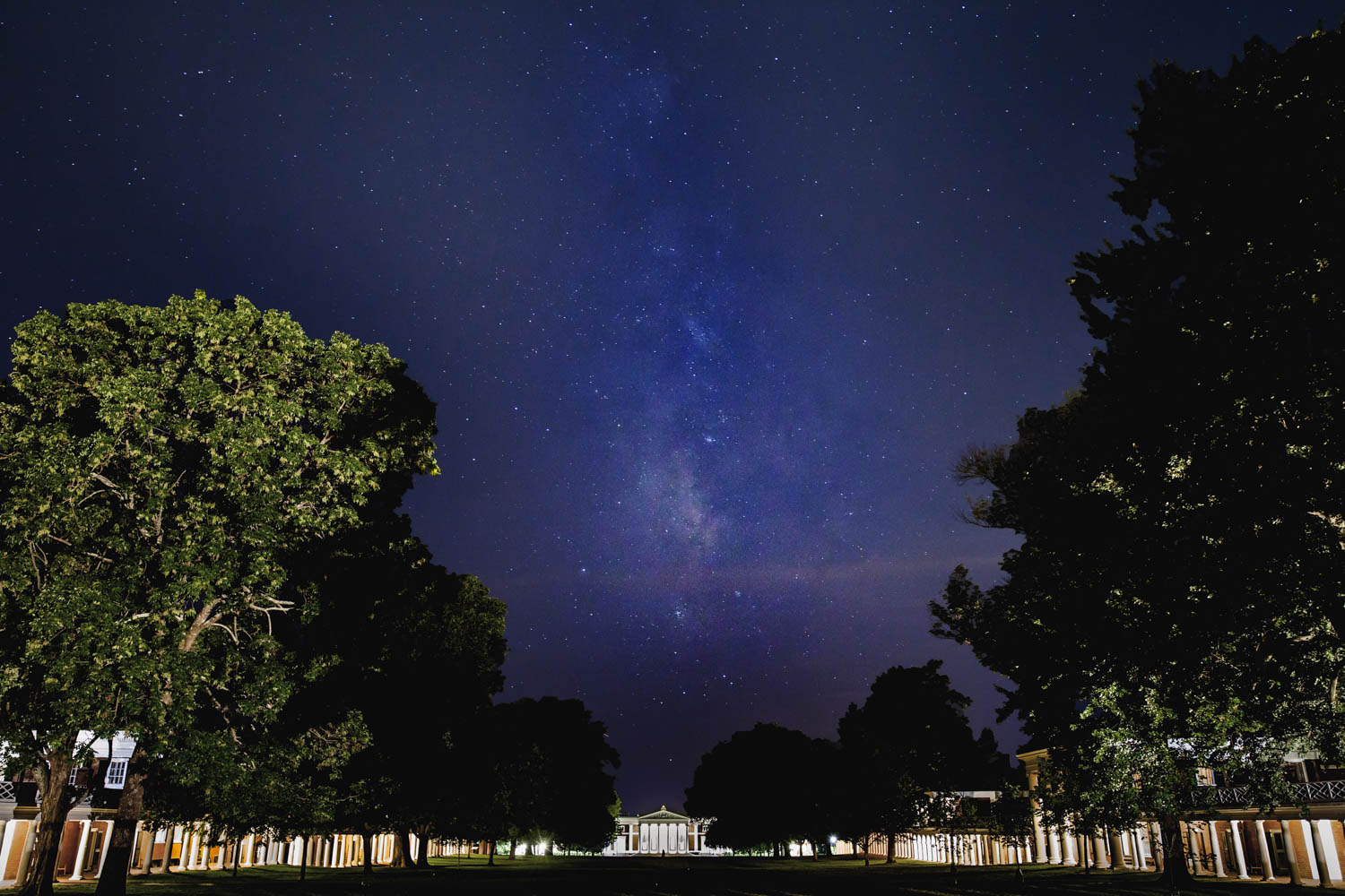 Cabell hall from the lawn at night with the milkway above it
