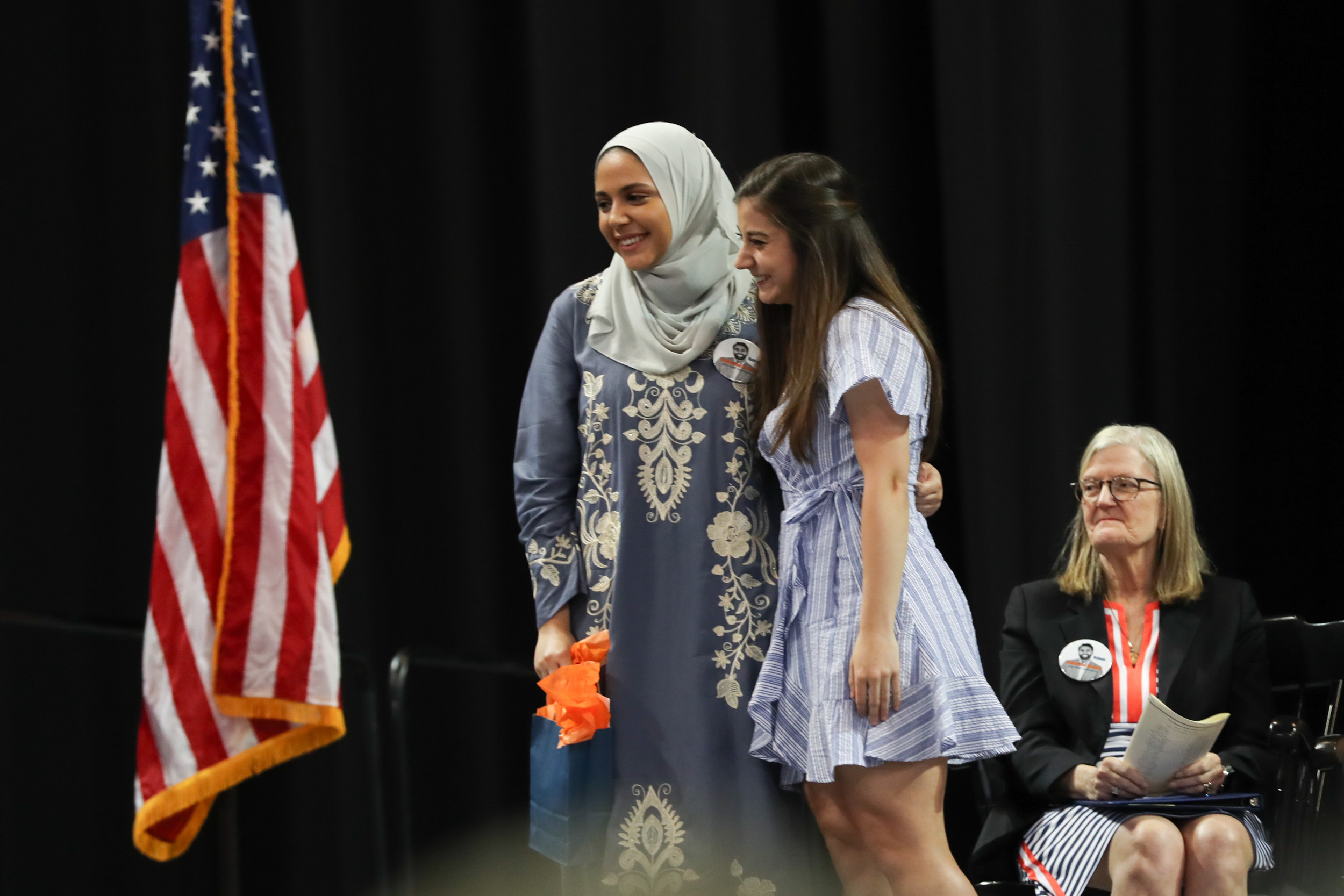 Brazao, right, and  Rawda Fawaz, pose on stage for photo