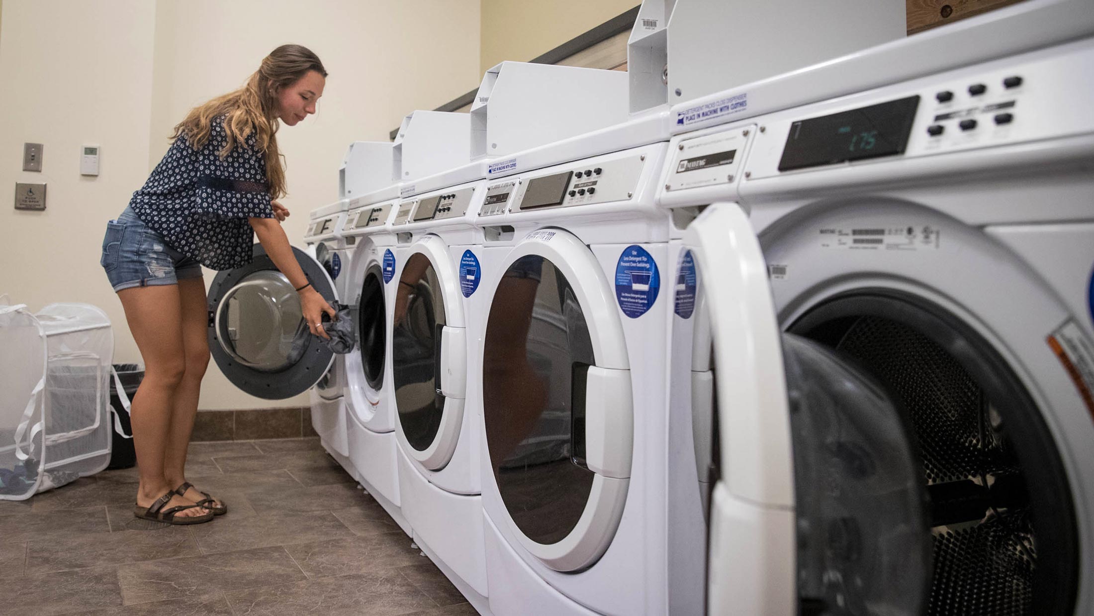 Student using a washing machine