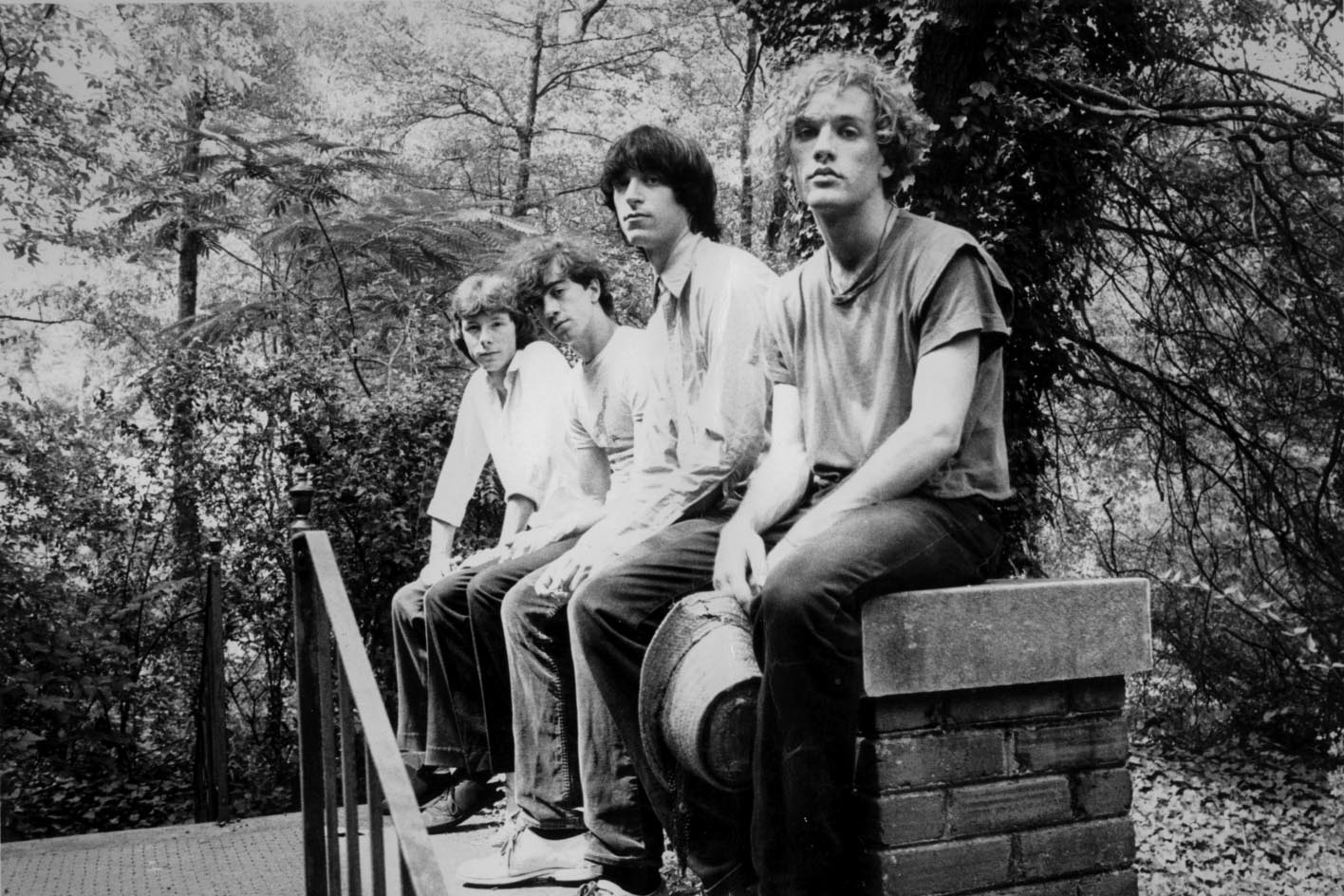 The members of R.E.M. stand on the patio of the Barber Street house