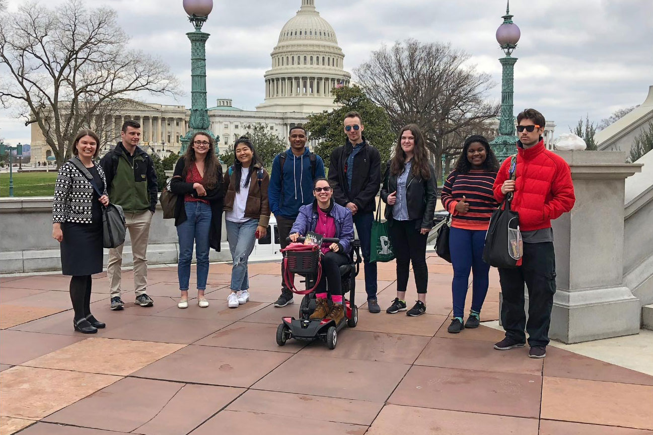 Ozment, left, stands on a DC sidewalk with the Capitol behind them