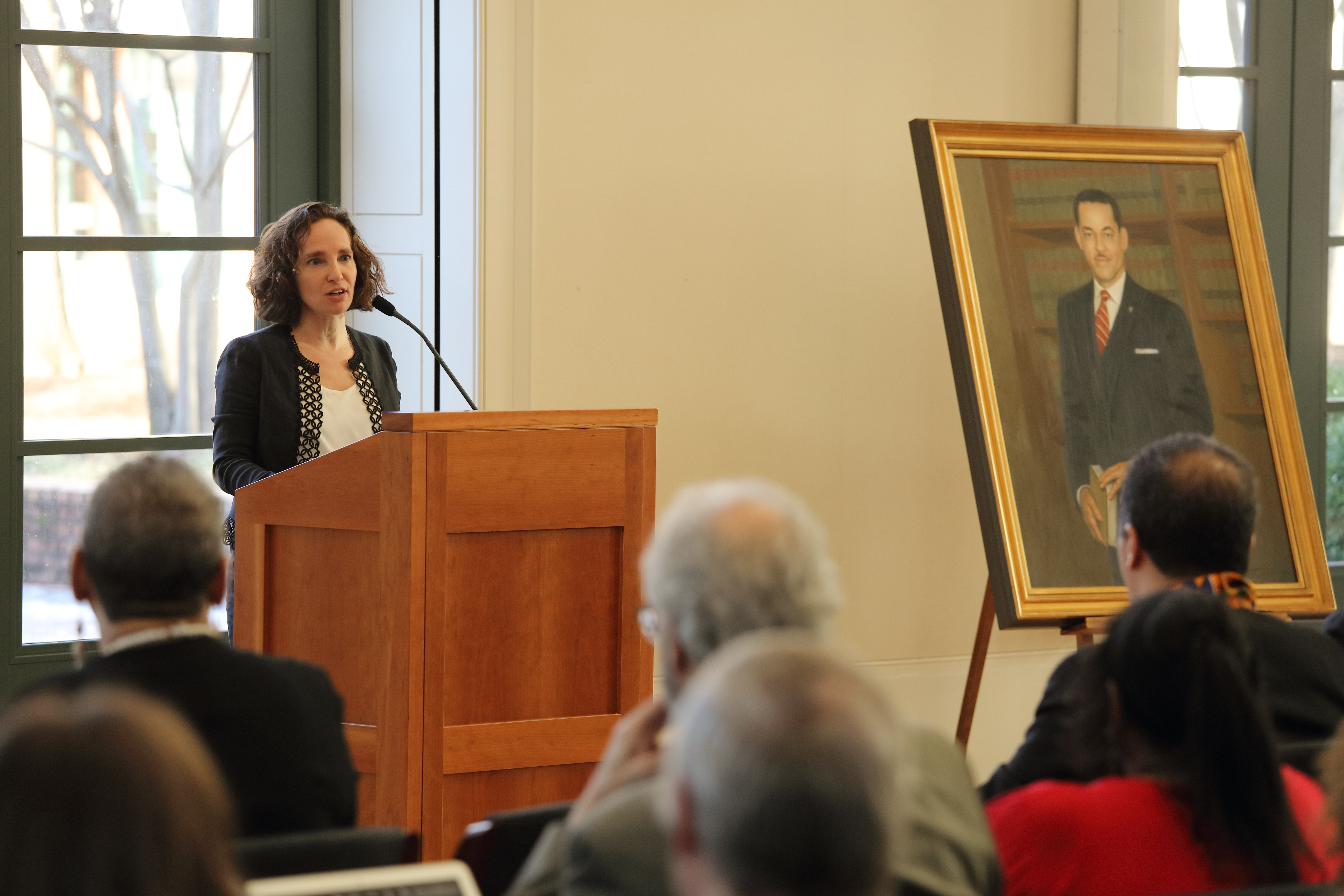 Risa Goluboff speaking at a podium