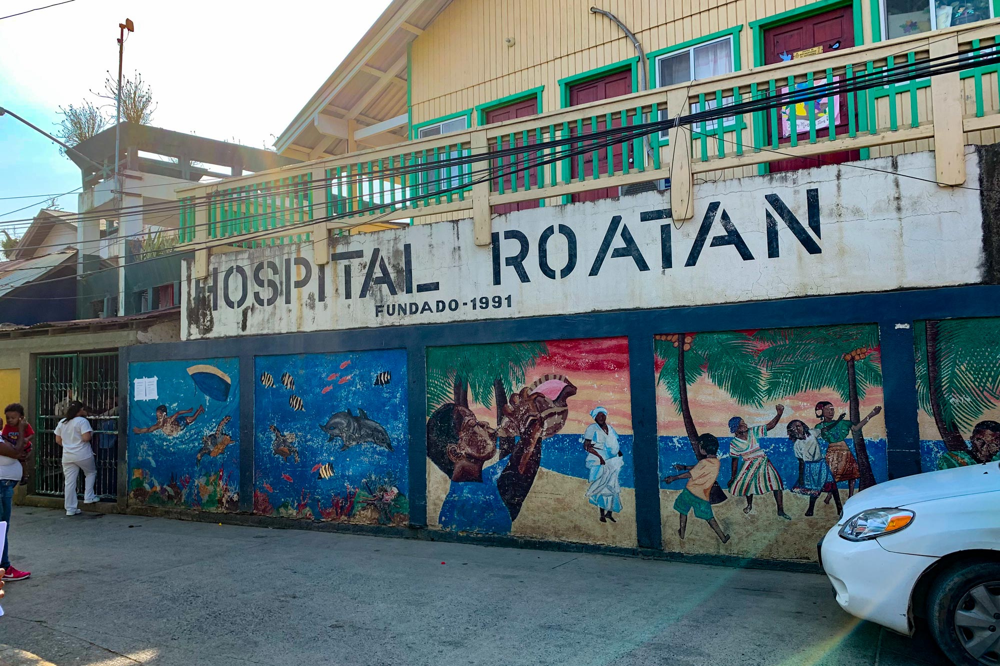  Roatan Hospital in Honduras with painted illustrations on the walls of people dancing and the ocean
