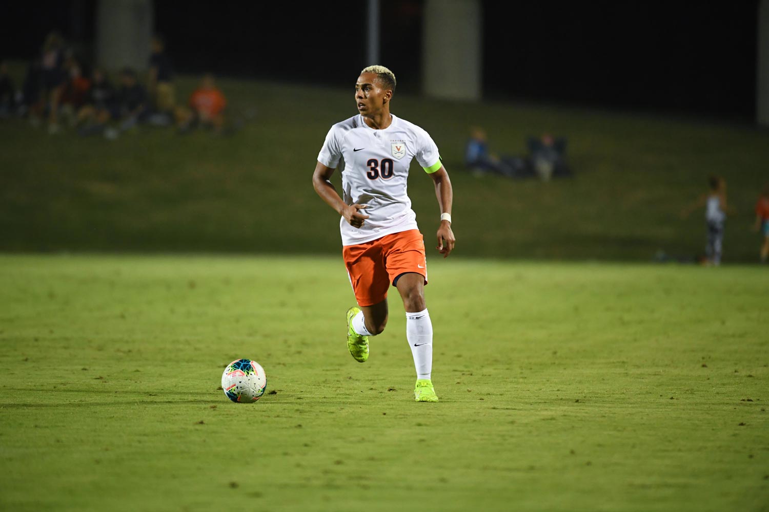 Robin Afamefuna runs down the field with a soccer ball during a game