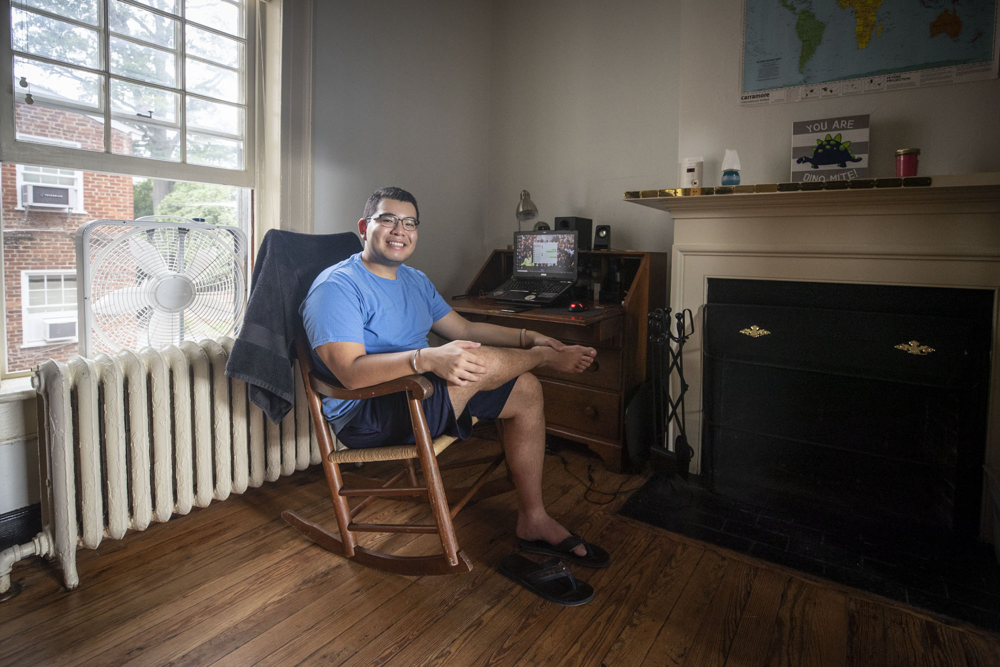 Rohan Ahluwalia sitting in rocking chair in their room on the Lawn