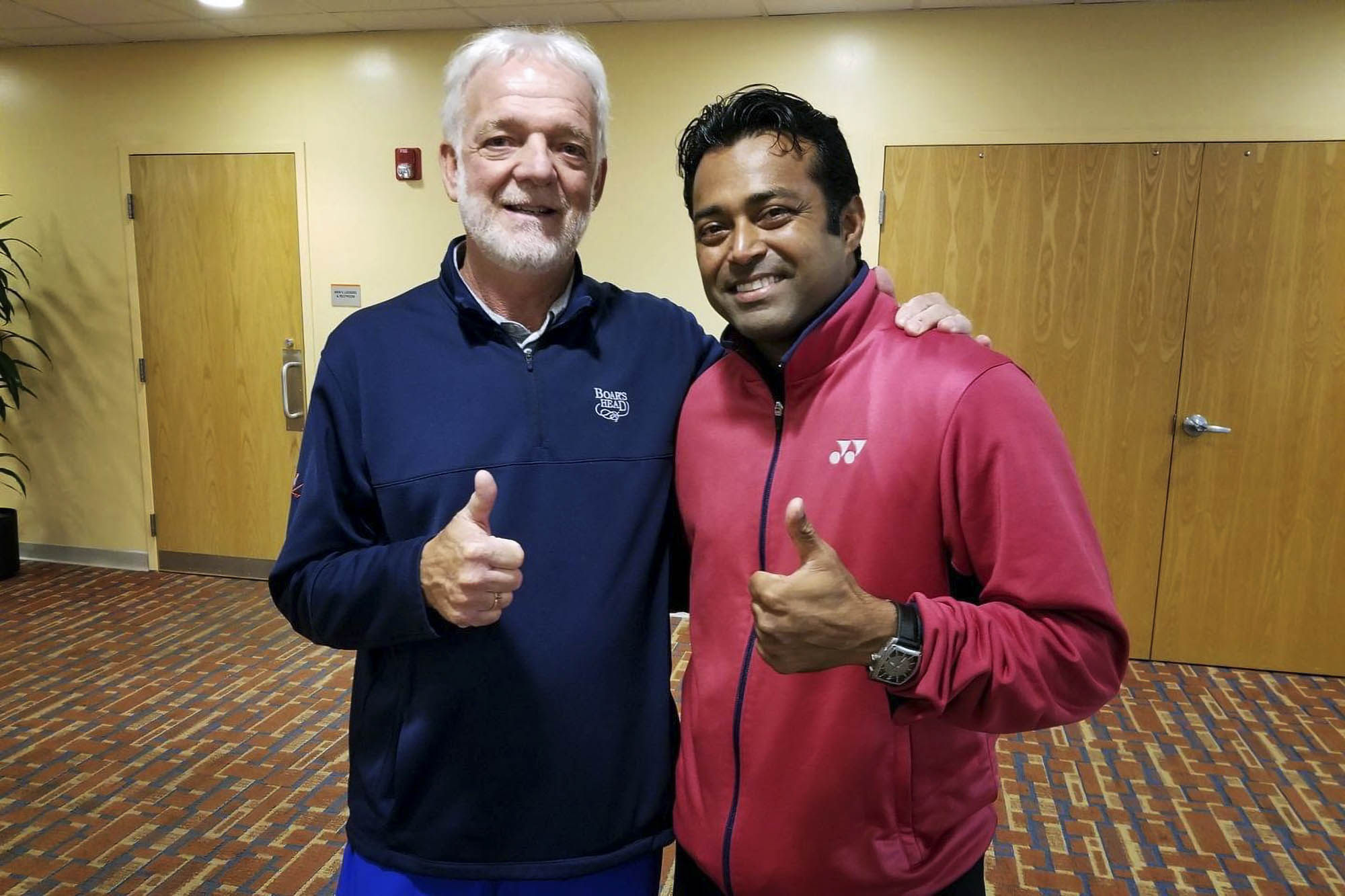 Manilla, left, and Leander Paes, right, give thumbs up to the camera