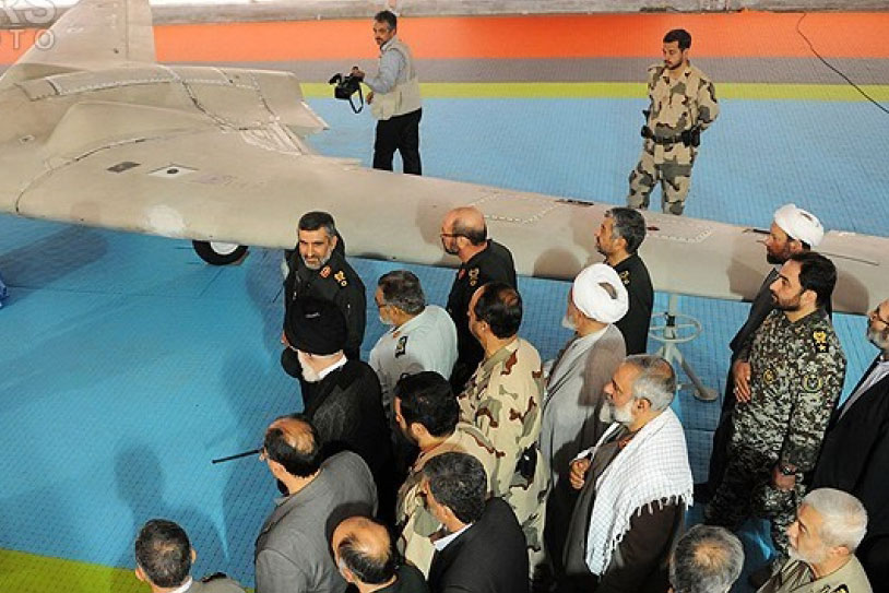 Group of Iranians surrounding a US RQ-170 stealth UAV aircraft
