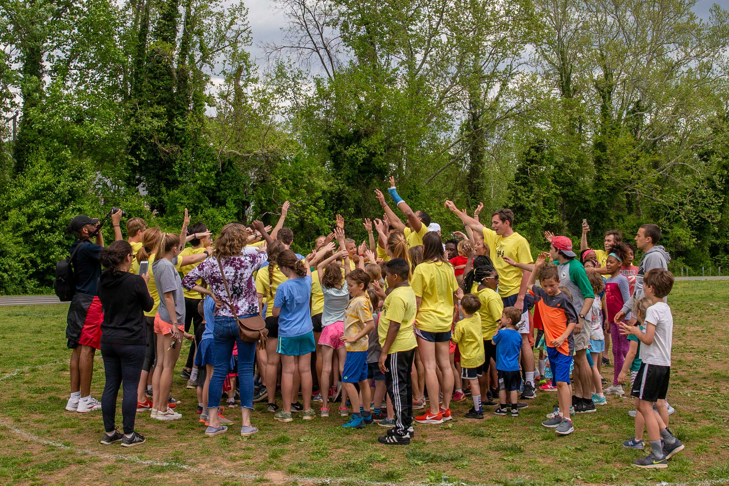 Children lift their arms in the arm and scream with excitement