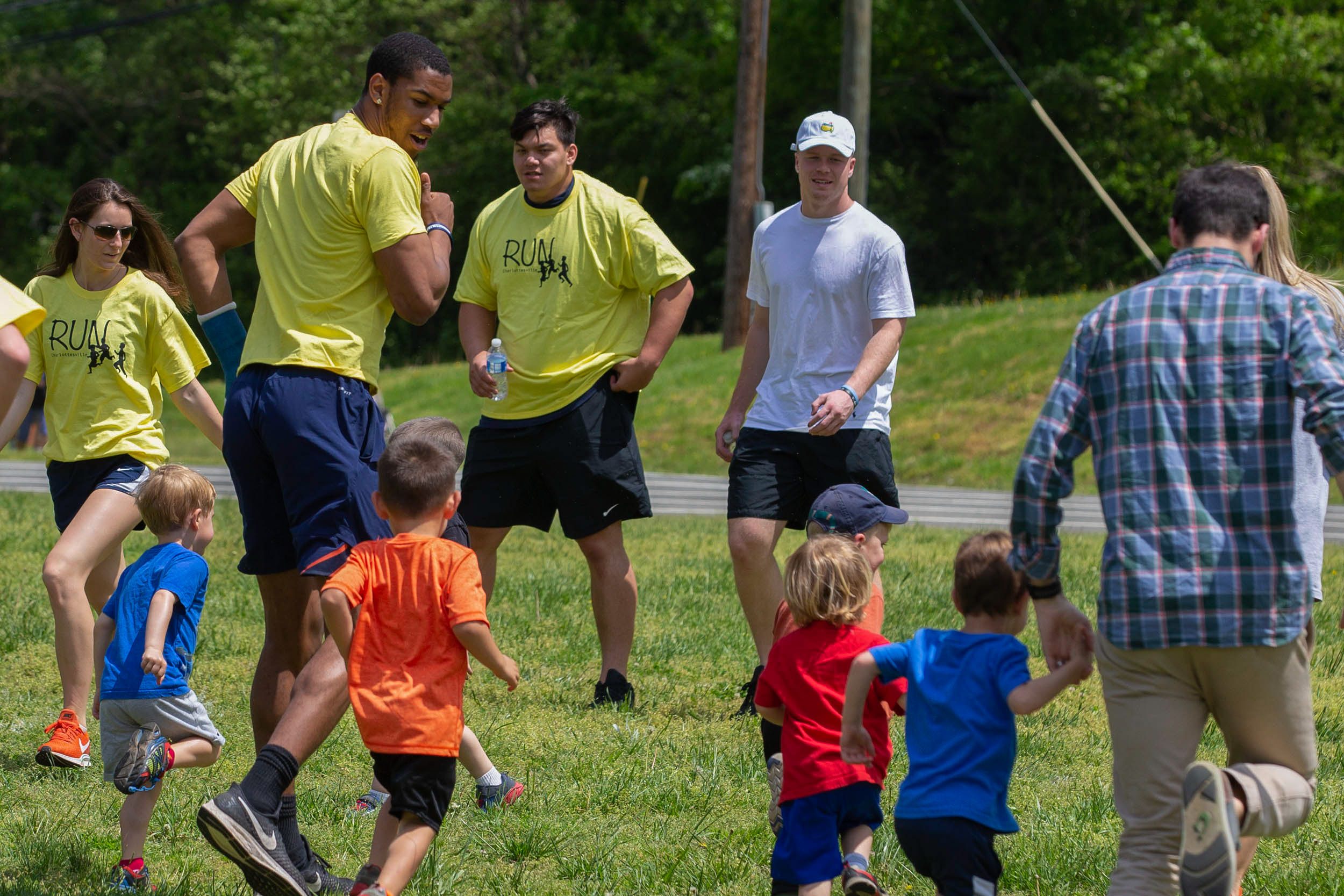 Charles Snowden runs with children down a field