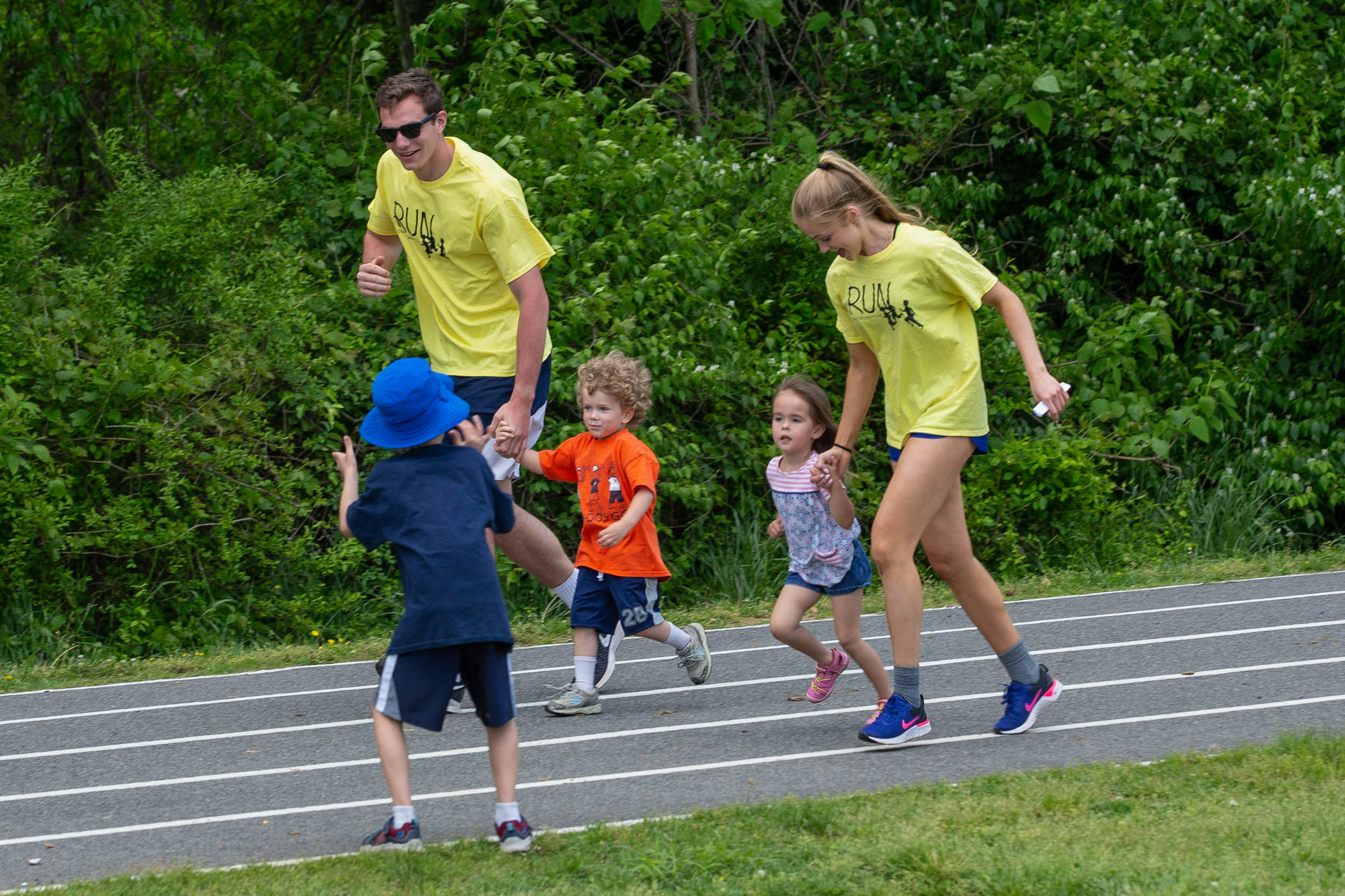 Austin Katstra, and Blankemeier run holding hands with two four year olds