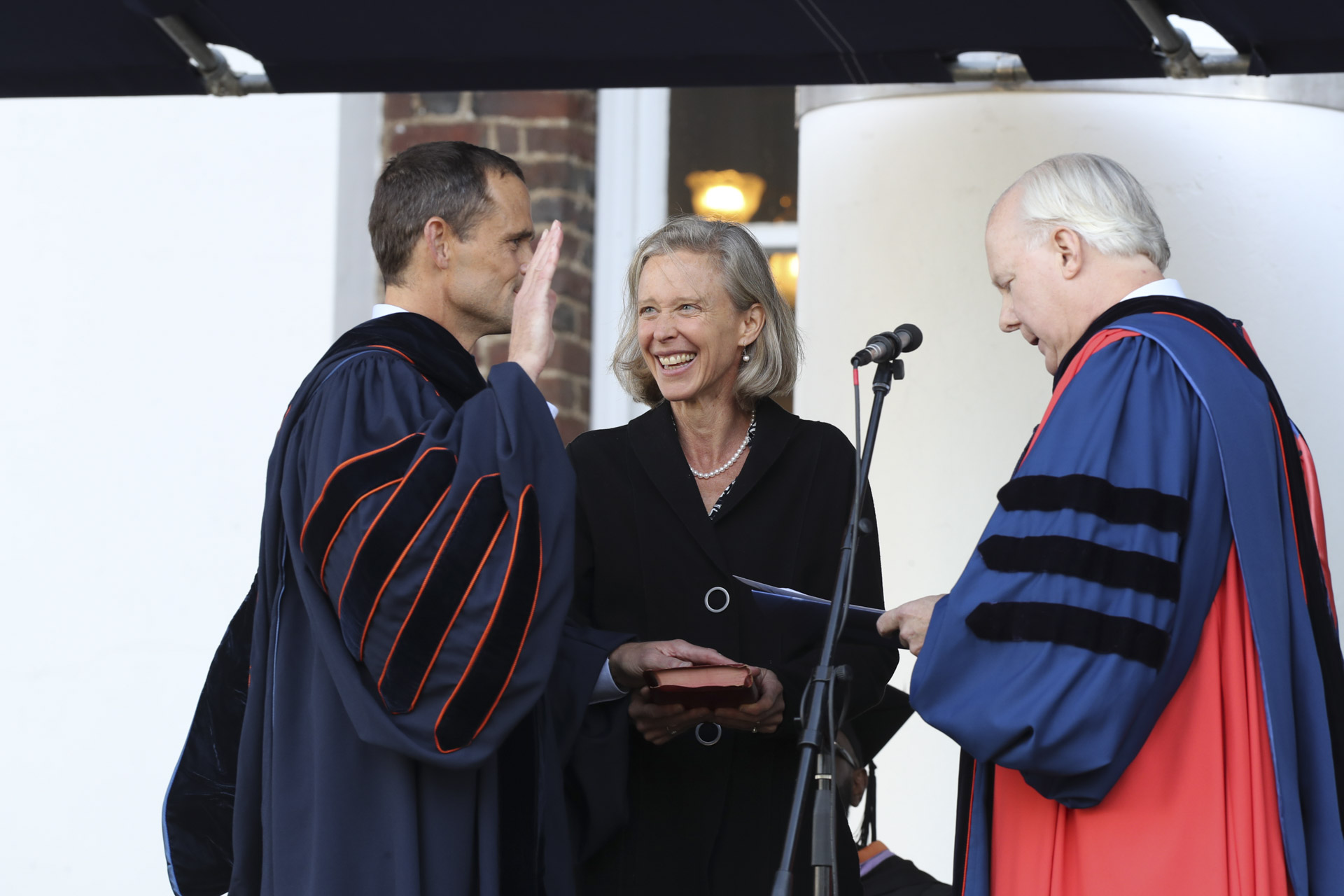President Jim Ryan takes an Oath with wife Katie holding a bible