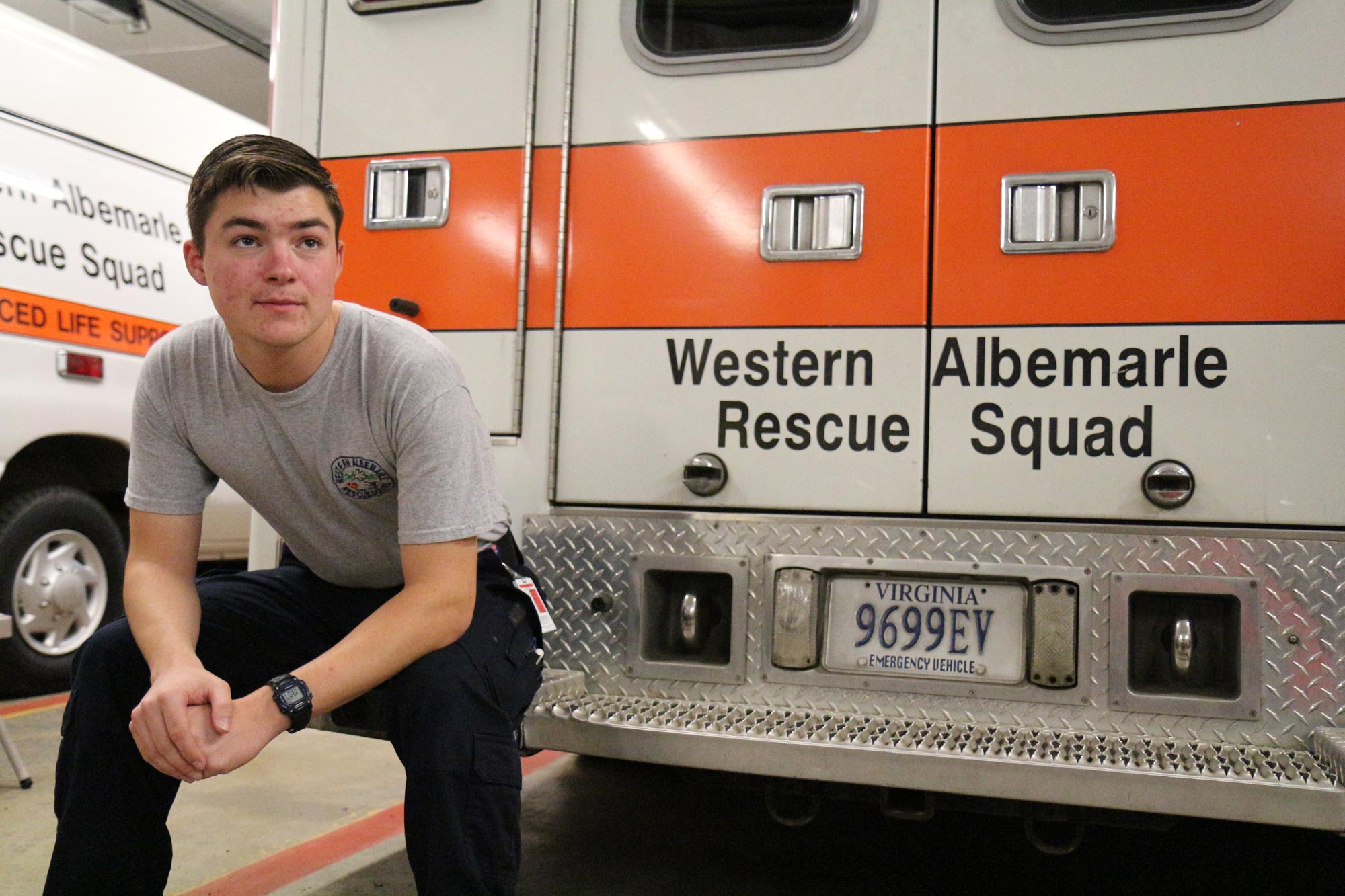 Ryan Thomas sitting on the step on the back of the Western Albemarle Rescue Squad