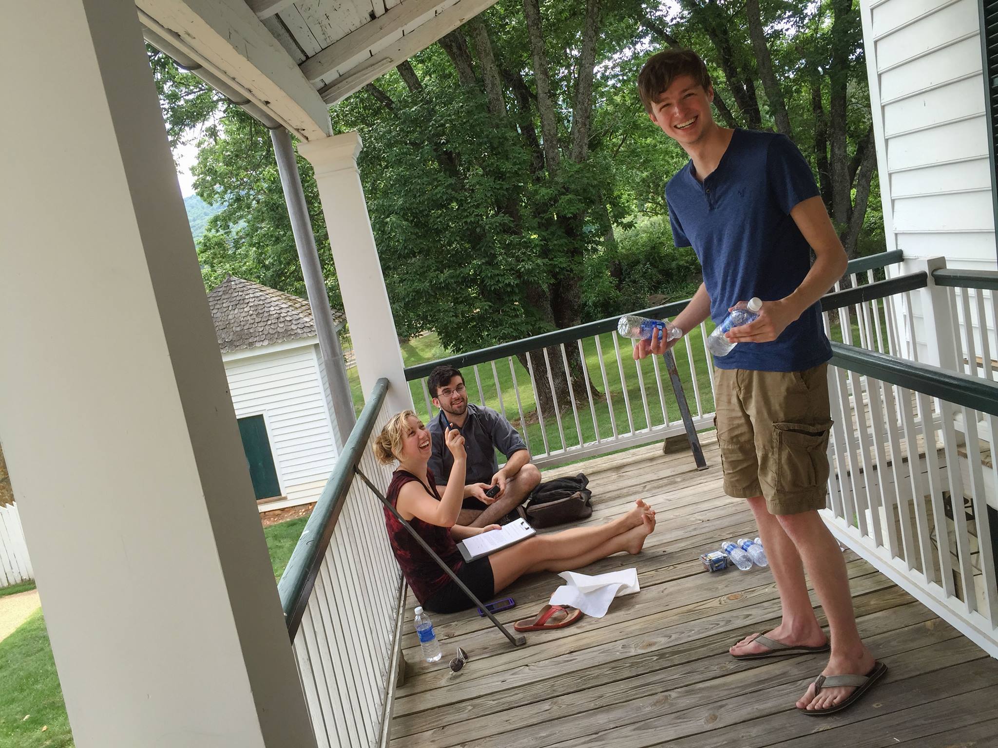 Sage Tanguay, left, Will Mullany and Brandon Sangston, standing, take a break from helping with filming at Ash Lawn-Highland. Photo by Eduardo Montes-Bradley.