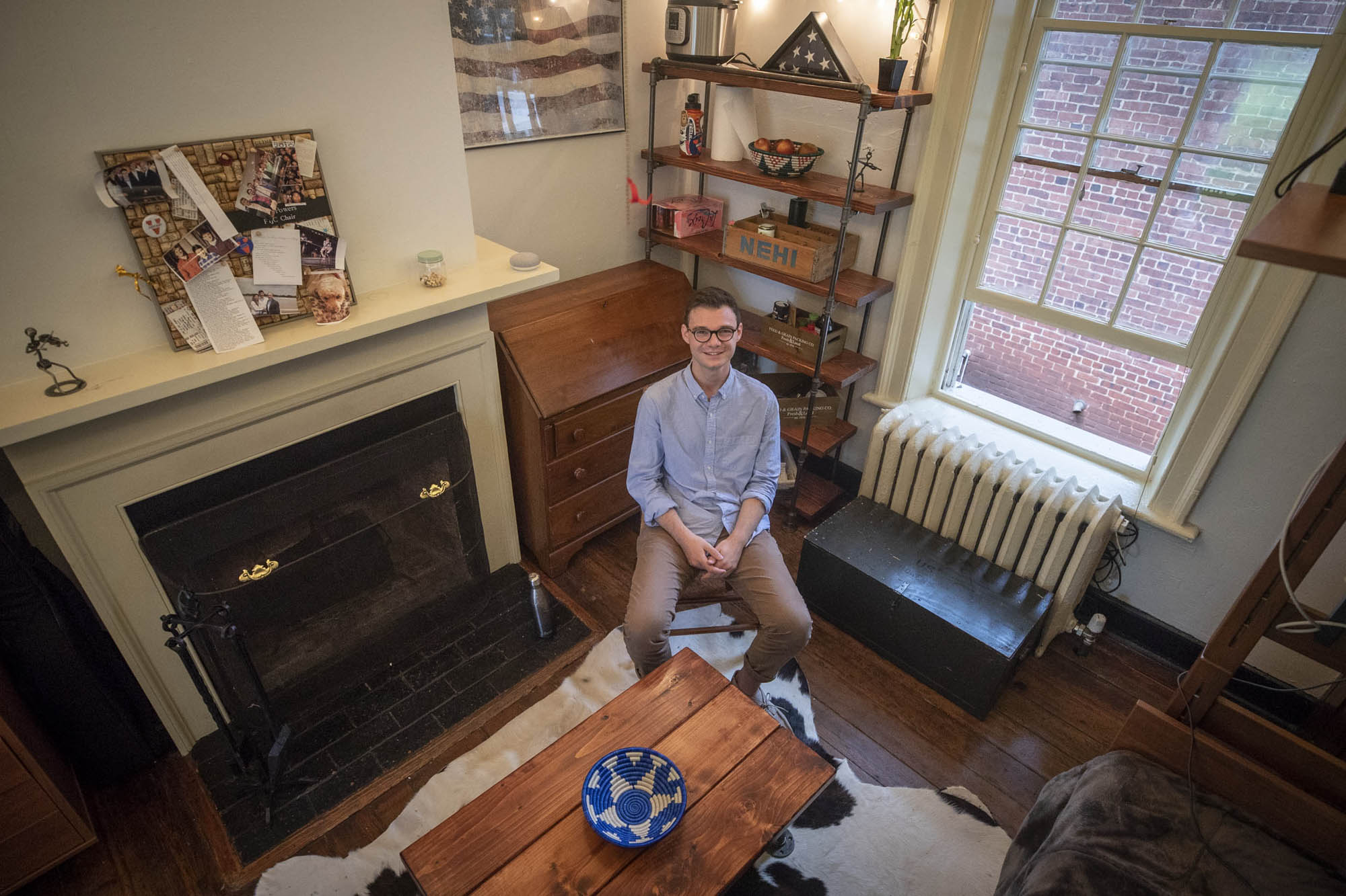 Sam Powers sits in chair in his Lawn room