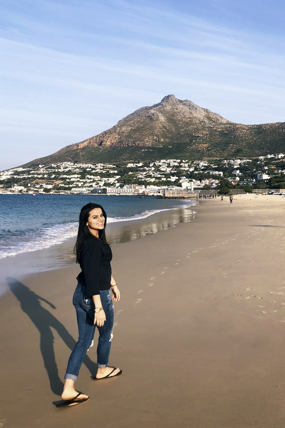 Sambriddi Pandey standing on a beach overseas