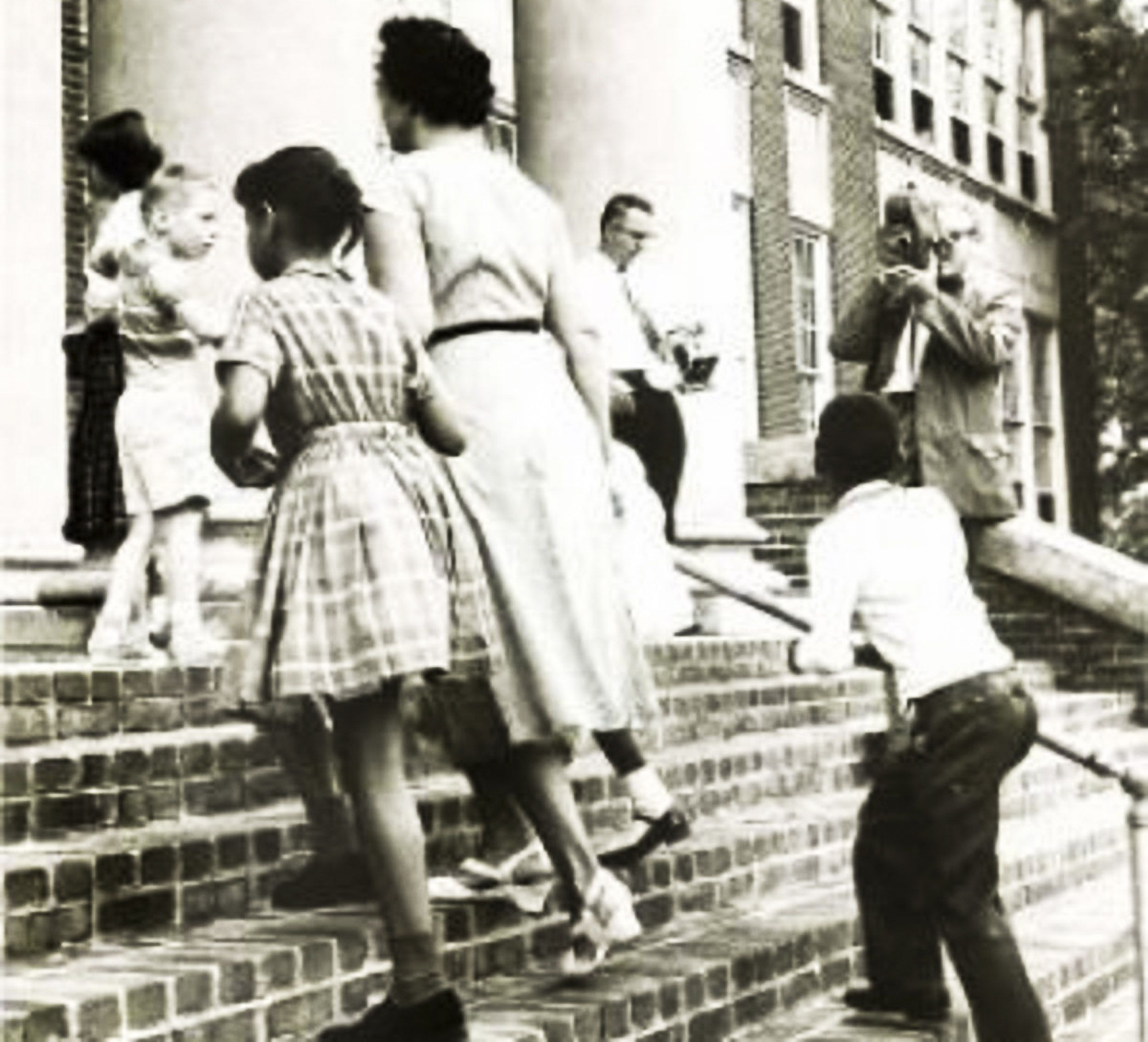 Black and white photo of African American students walking up the steps of school