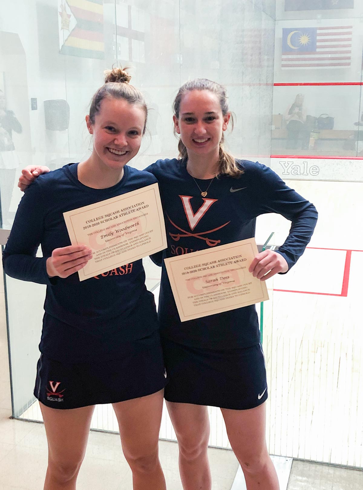 Emily Woodsworth, left, and Sarah Doss, stand together for a picture while holding certificates for being named the College Squash Association
