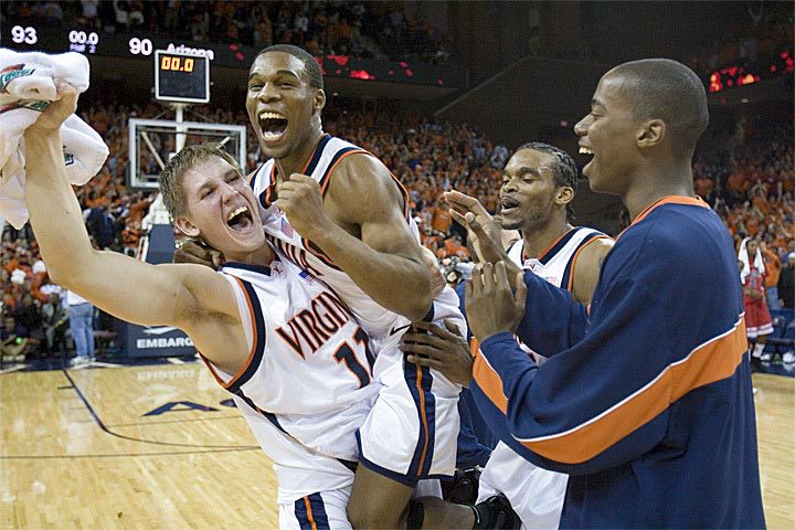 UVA basketball players scream, jump, and clap with excitement after a win