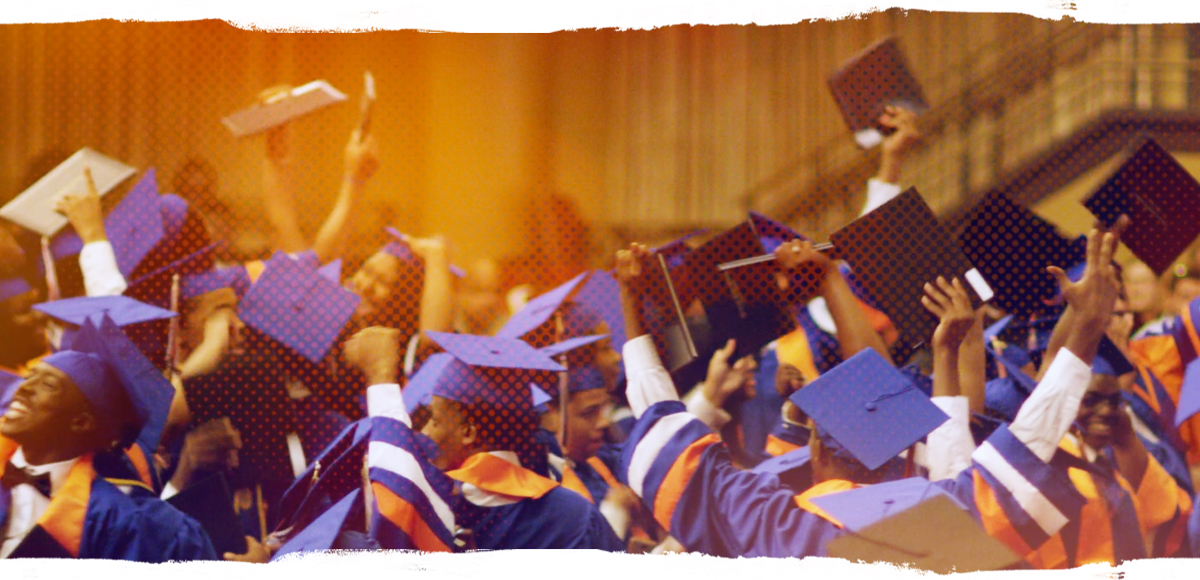 Graduates raise their hands in celebration