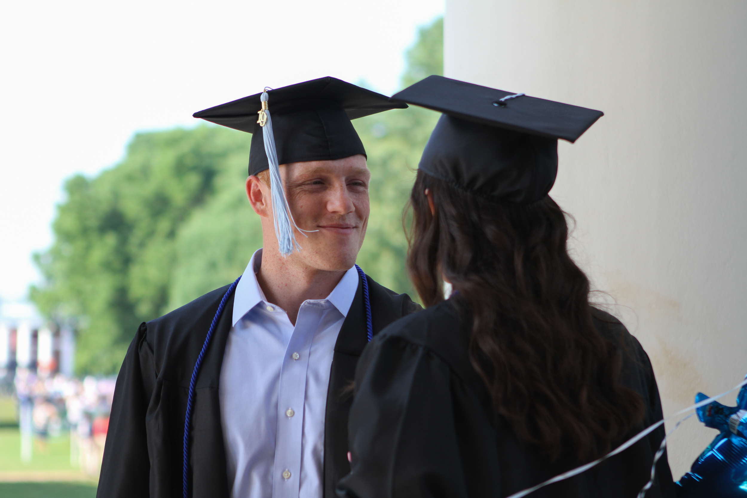 Two graduates looking at each other
