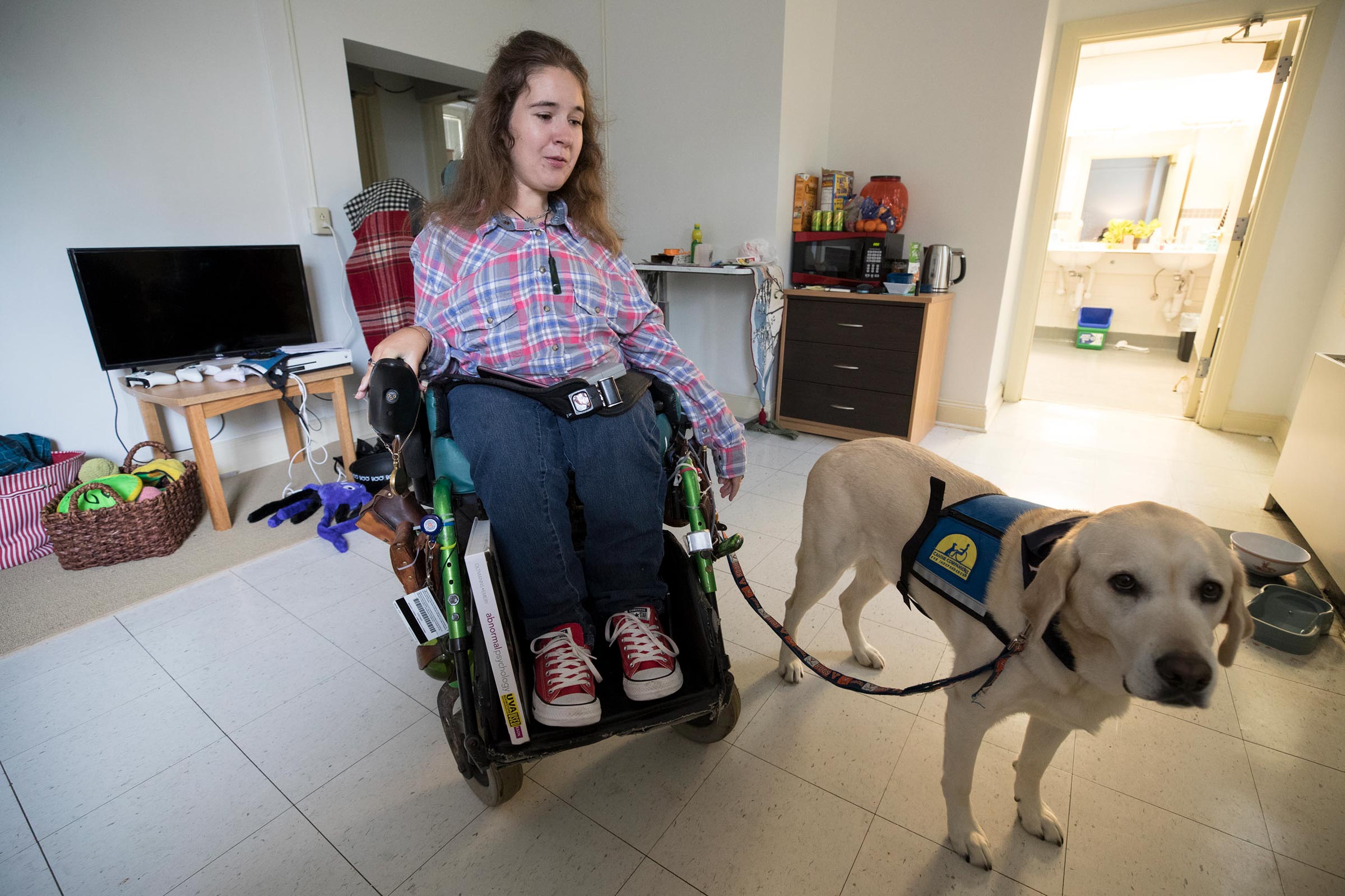 Shea Megale and her service dog in their apartment