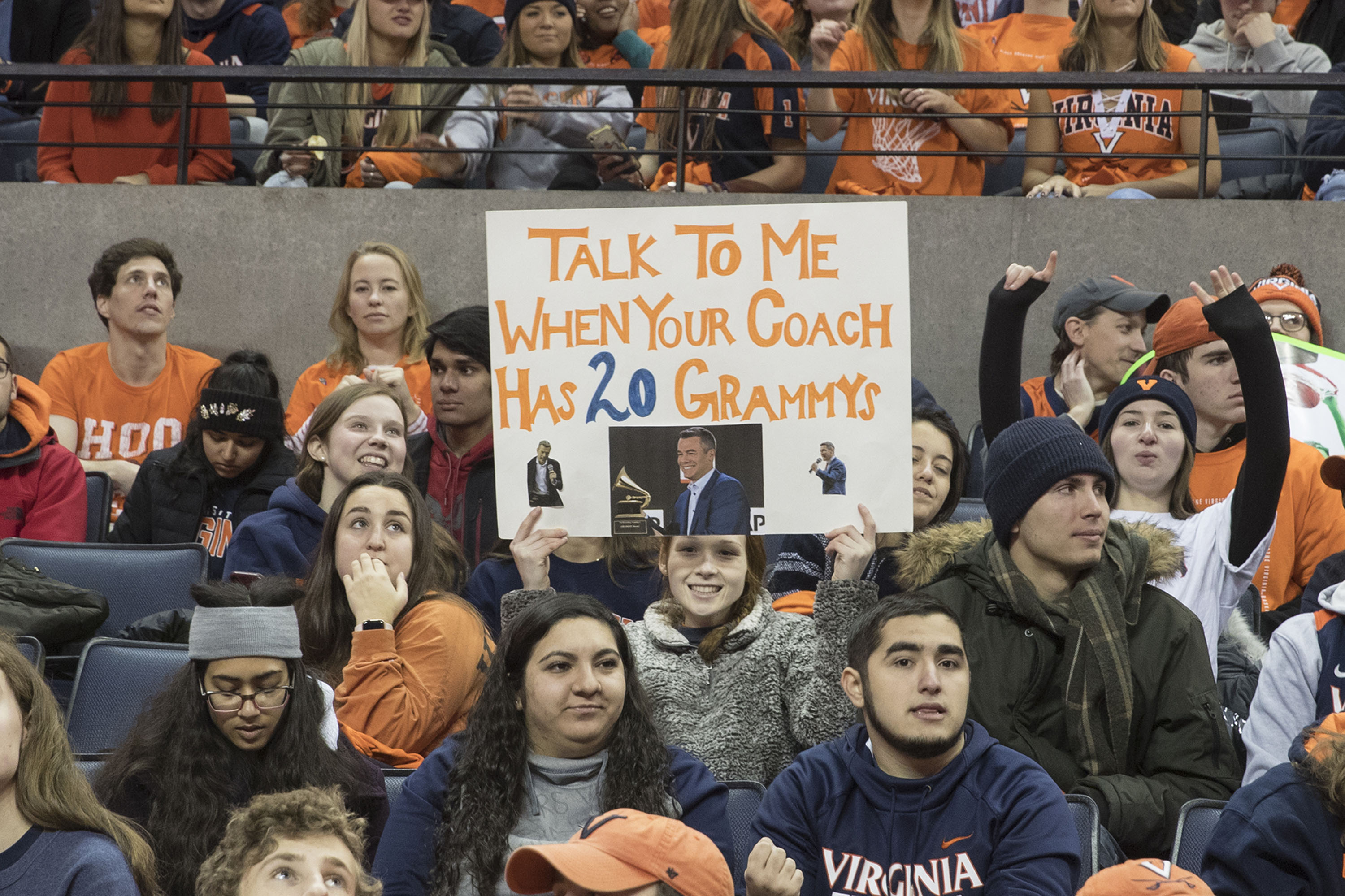 Fan holding a sign  that says: Talk to me when your coach has 20 grammys
