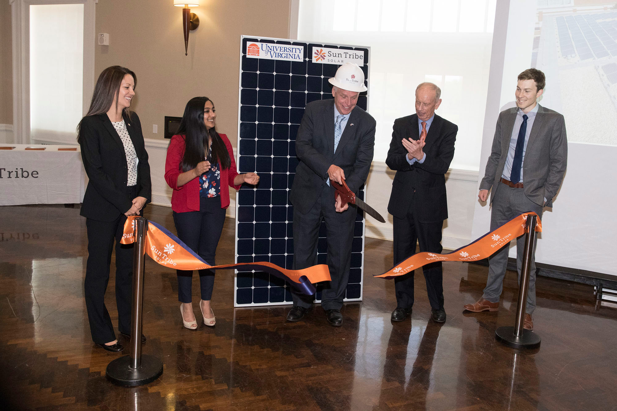 McAuliffe cut a symbolic ribbon for the array, which has been in place since February and is on its way toward producing nearly 200,000 kilowatt hours of electricity this year.