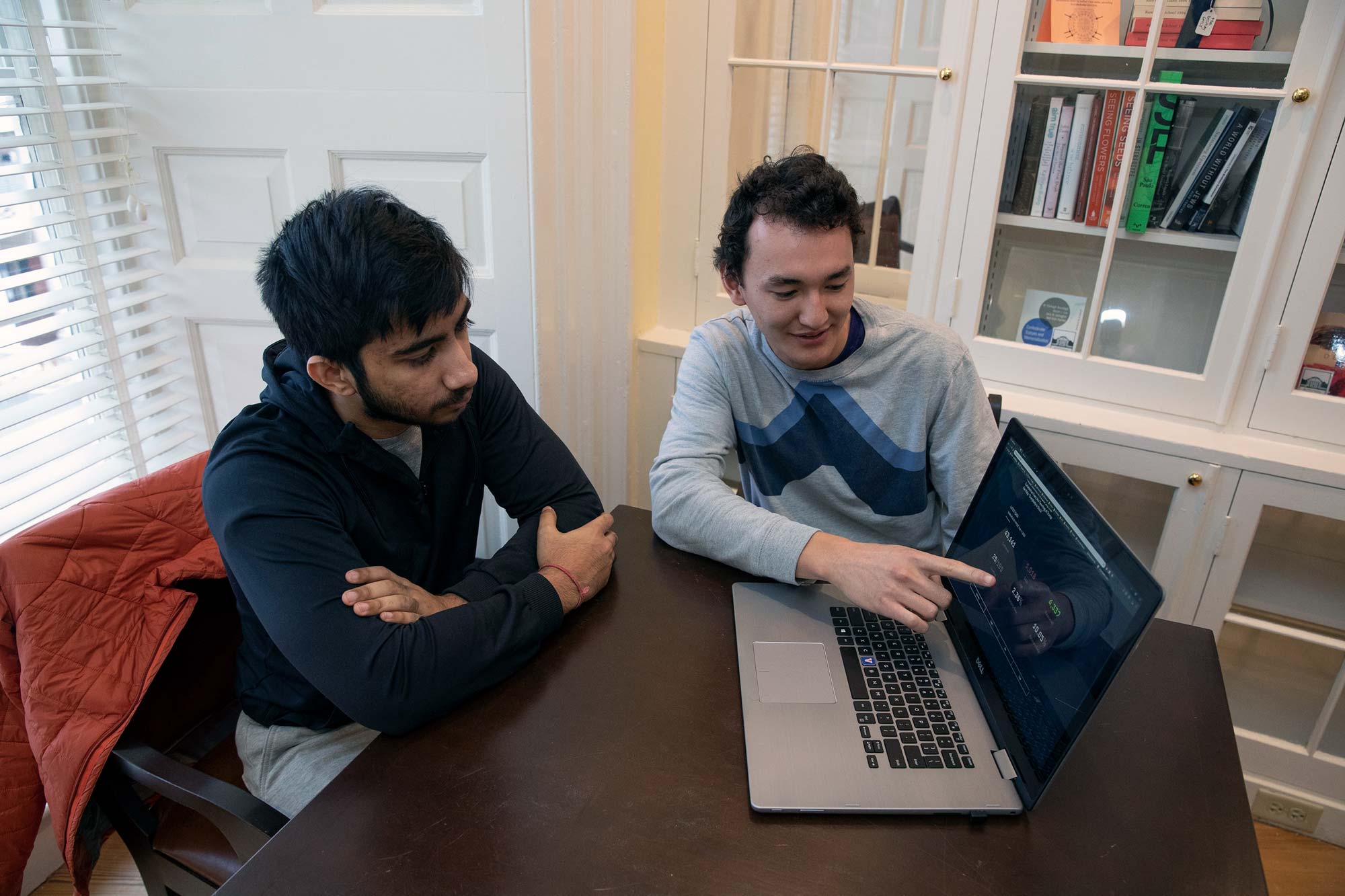 Soukarya Ghosh, left, and James Yun, right working together on a laptop