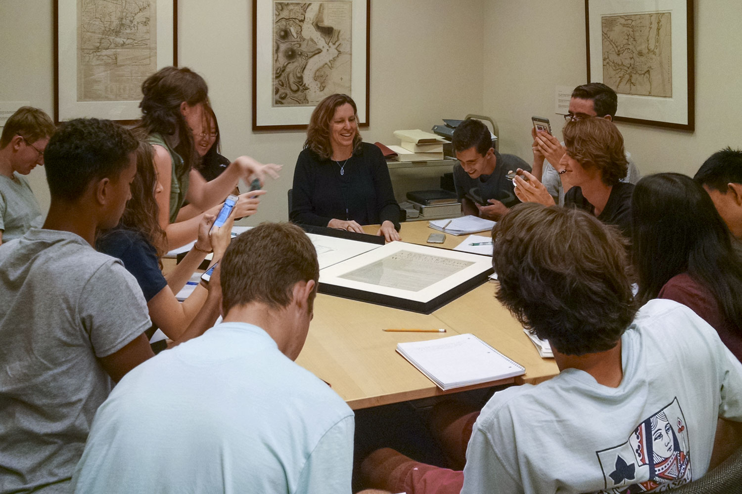 Molly Schwartzburg showing a framed copy of one of the first printed copies of the Declaration of Independence