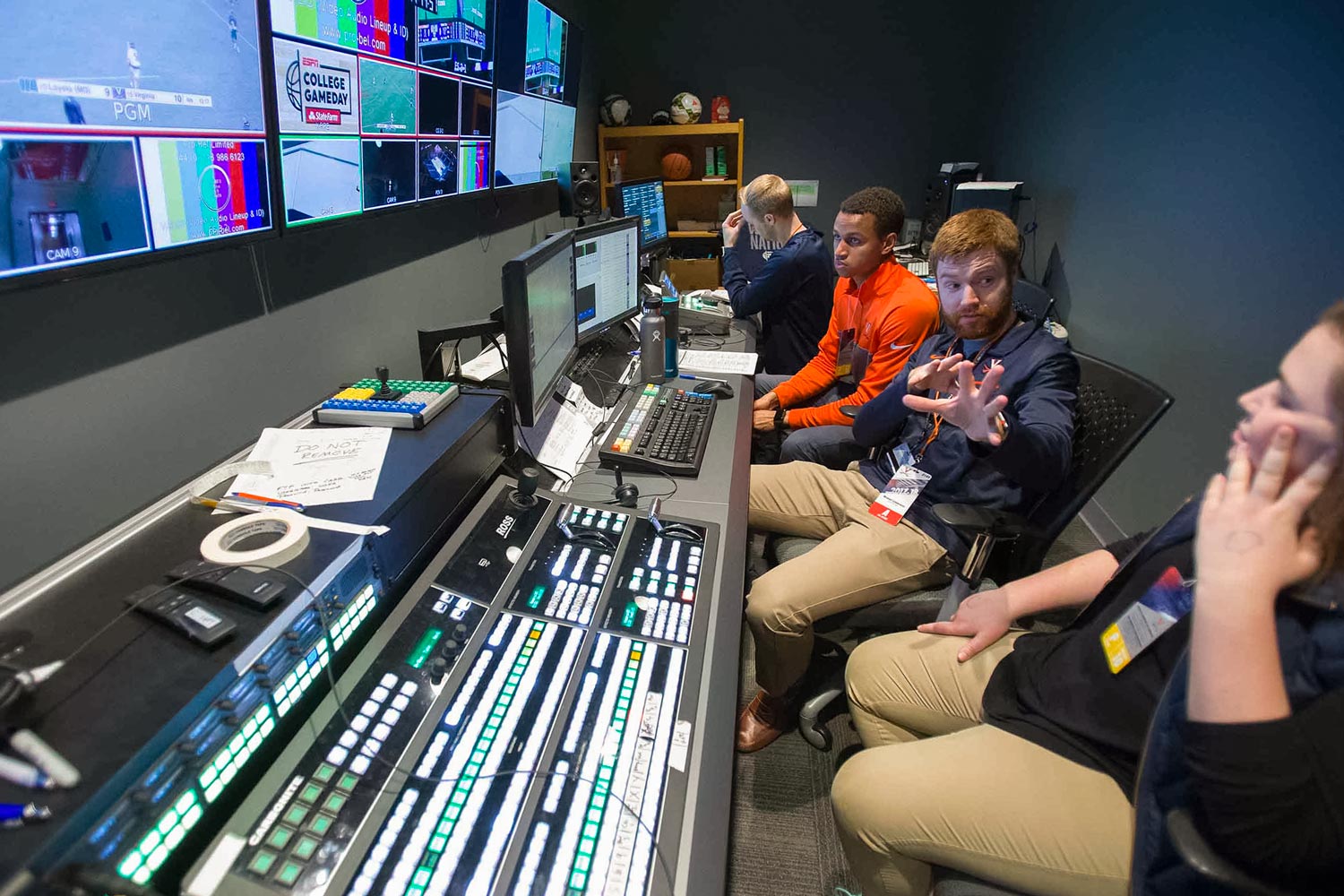 UVA Video Services team sits in a both running a sound booth