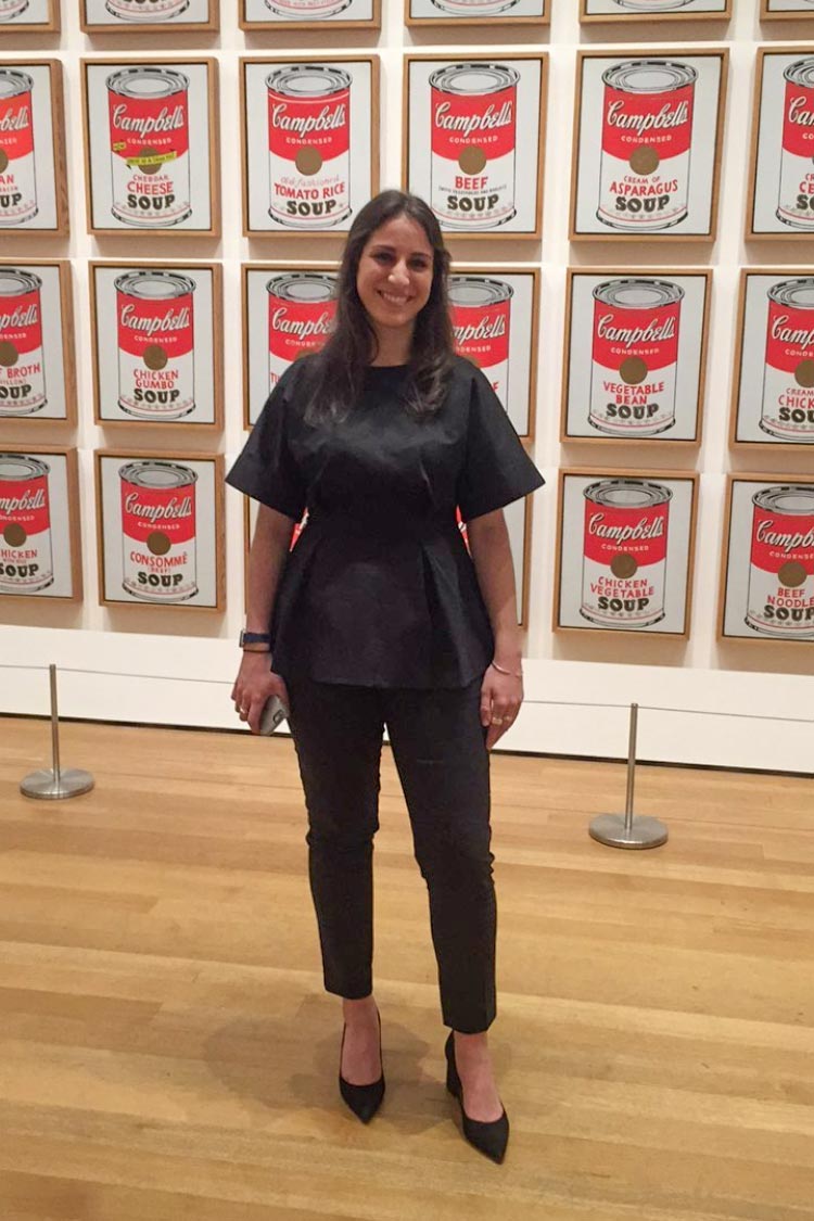 Stephanie Katsias stands in front of a display of Campbells soup cans