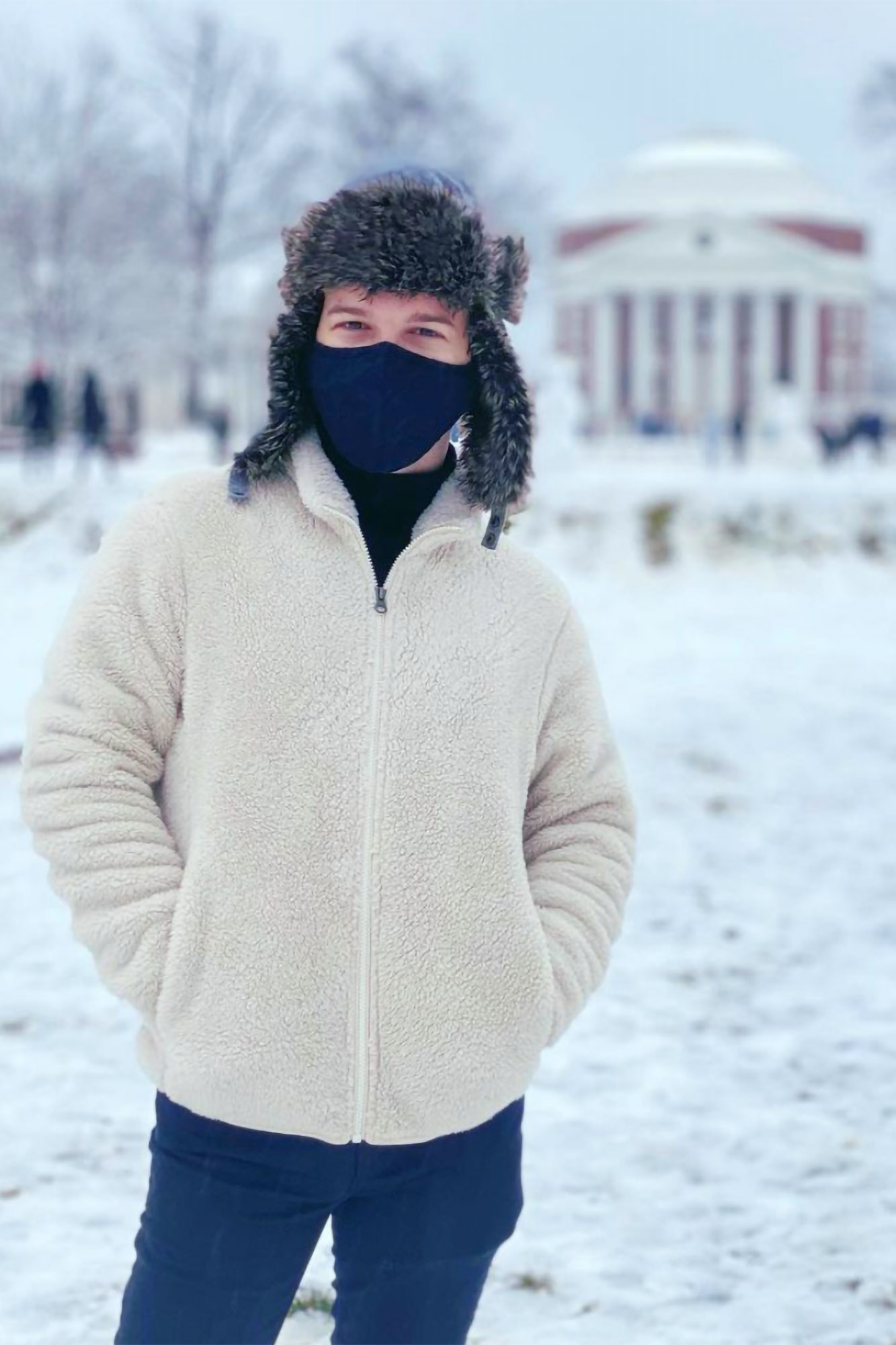 Clay Sterling bundled up in warm clothing while walking on the Lawn after a fresh snow