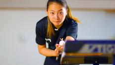 Portrait of Jie Lu about to serve in table tennis
