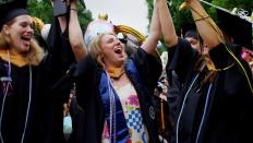 Graduates put their hands up in celebration