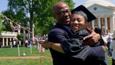 Happy grad hugs her dad in celebration 