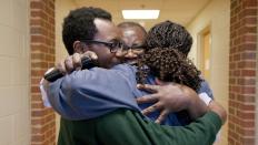 A family embraces in an emotional hug