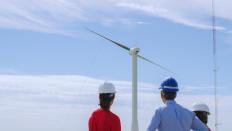 People looking at a wind turbine