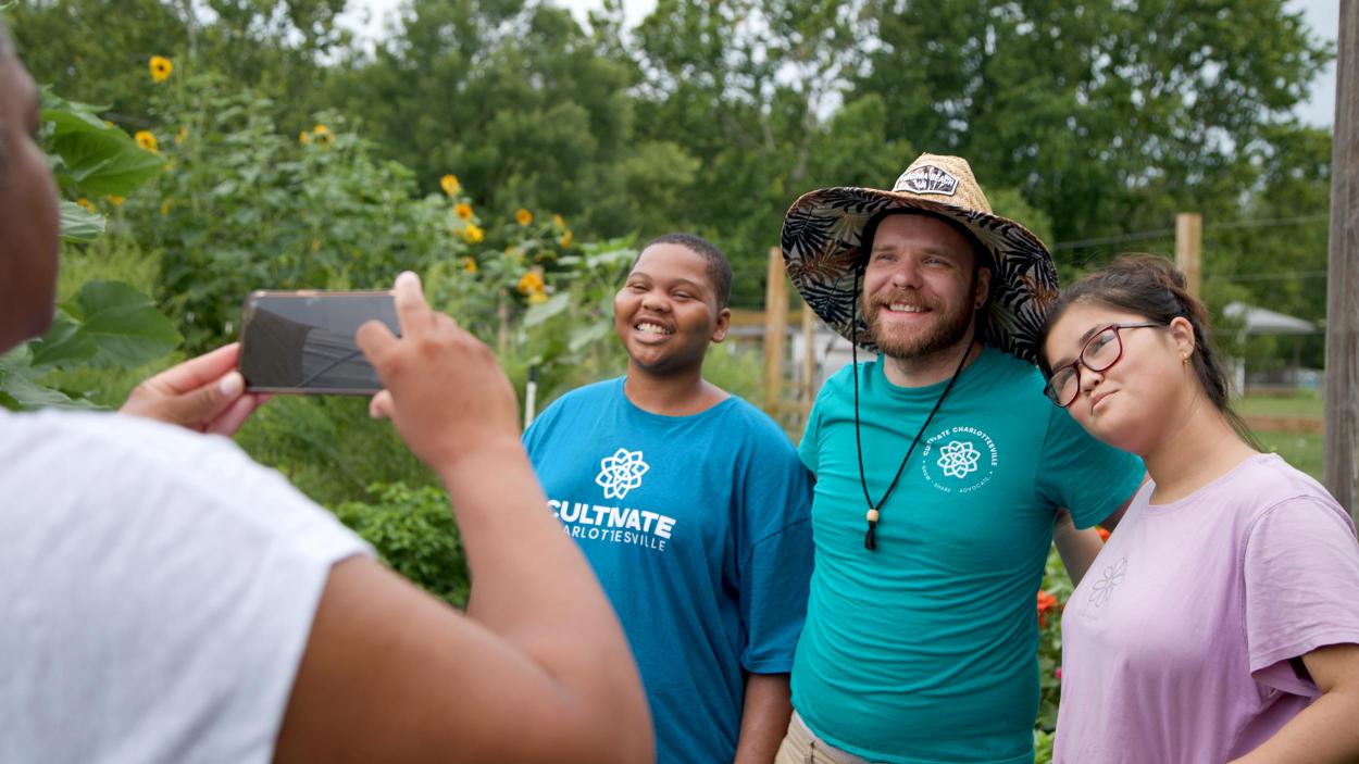 Three people pose together for a photo