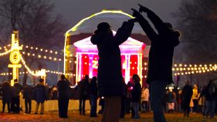 sihlouettes pointing and watching light shows in front of the UVA Rotunda during Lighting of the Lawn 2025.
