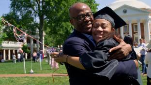 Happy grad hugs her dad in celebration 