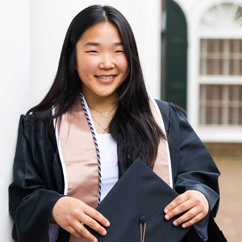 Anna Lee holding her graduation cap for a photo session