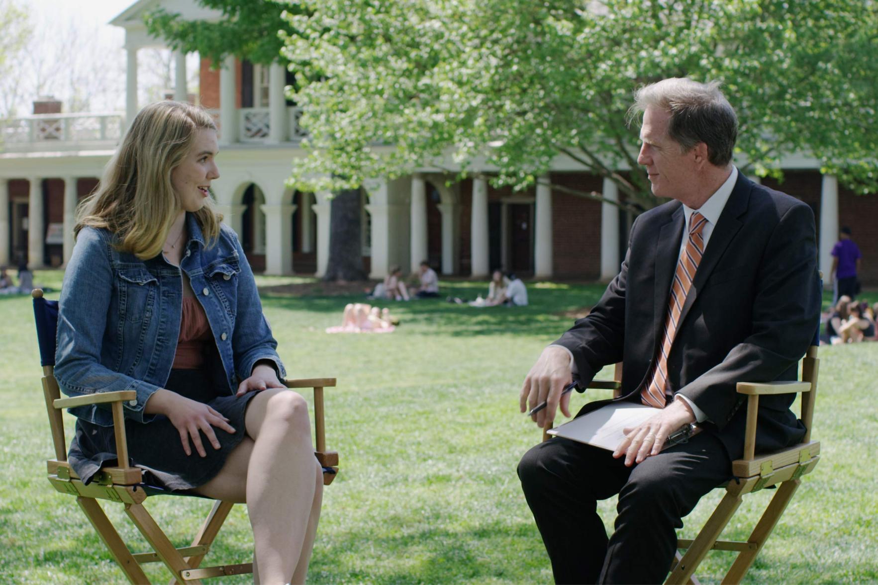 Erica Szymanski and Mike Mather talking together in directors' chairs on the Lawn
