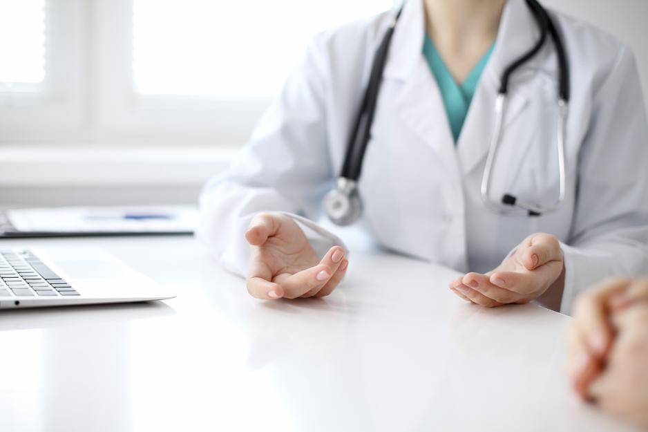 Healthcare provider talking to a patient at a desk