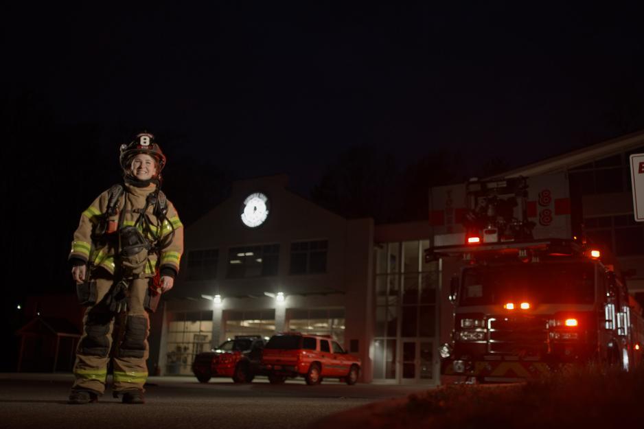 Portrait of Ali Kyle in her fire fighter uniform outside the emergency room.