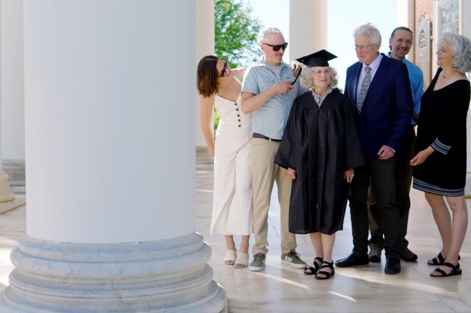 Mary Ann Parr with her cap and gown, surrounded by people