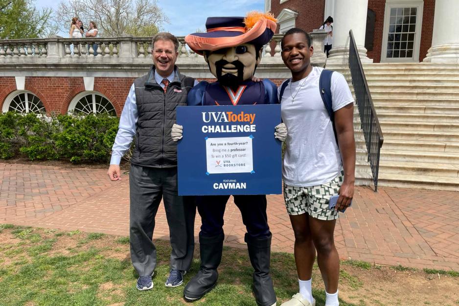 Brendan Gamor, right, poses with Cavman, middle, and professor Michael Suarez, right