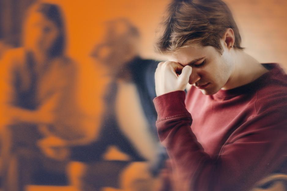 a teen holding their head in their hands while their parents argue in the background