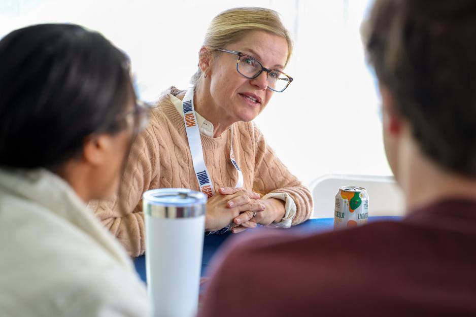 Adjunct law professor Ashley Waters Gundersen talking with two students