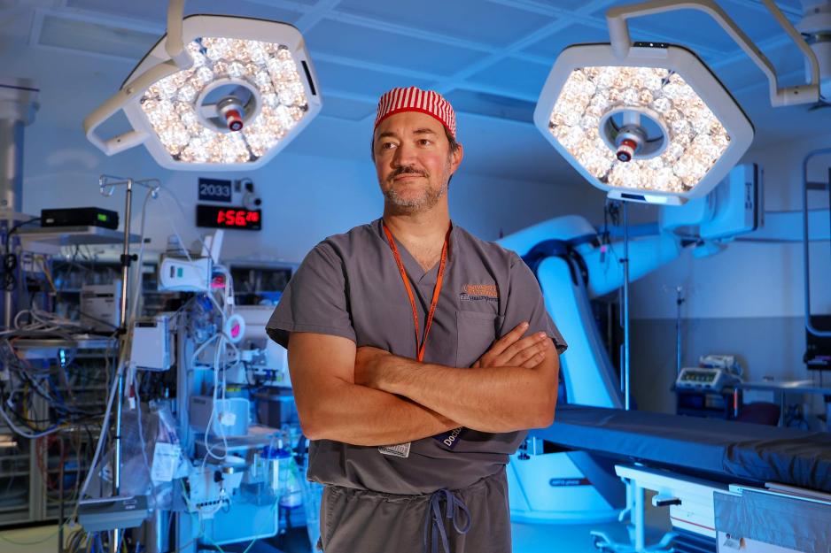 Dr. Jade Nunez standing with his arms crossed in an operating room