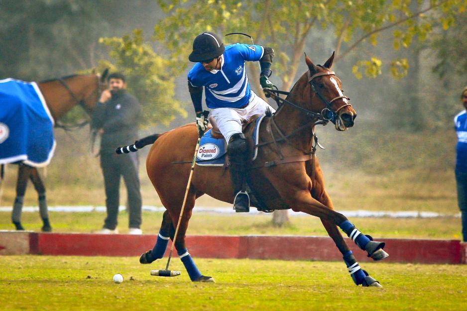 Mohammad Saqib Khakwani riding a horse playing polo.